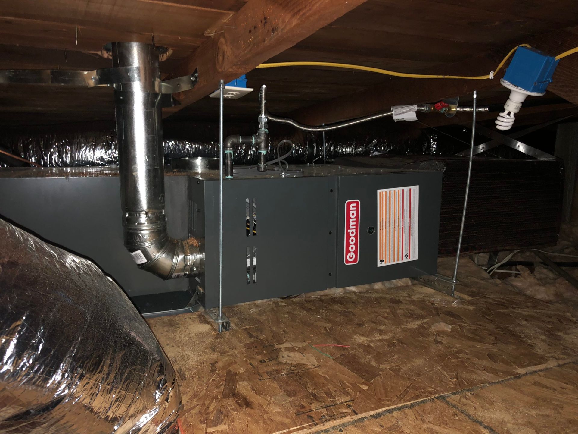 Exterior view of a sleek modern house with air source heat pumps neatly installed on the outside.