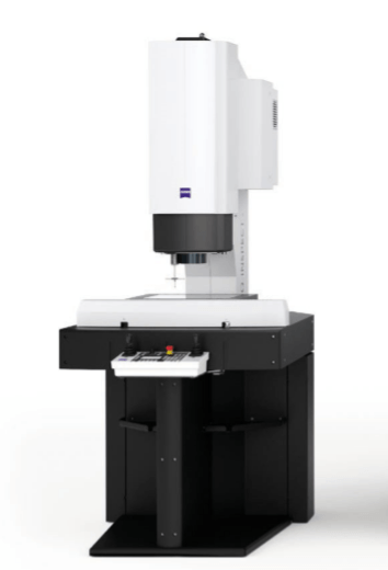 A white machine is sitting on top of a black table.