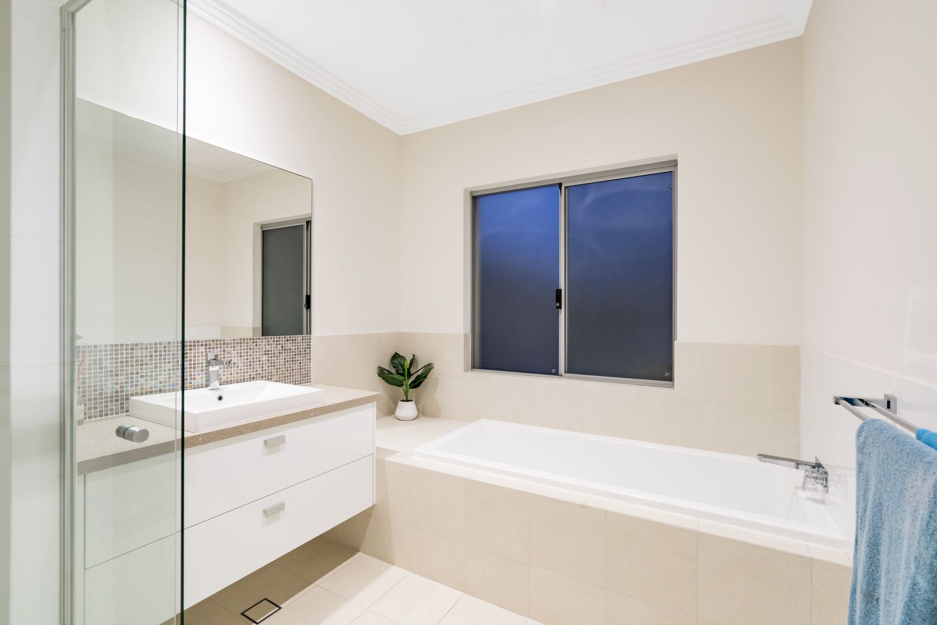 A Bathroom with A Tub, Sink, Mirror and Window — Colour Splash in Central Coast, NSW