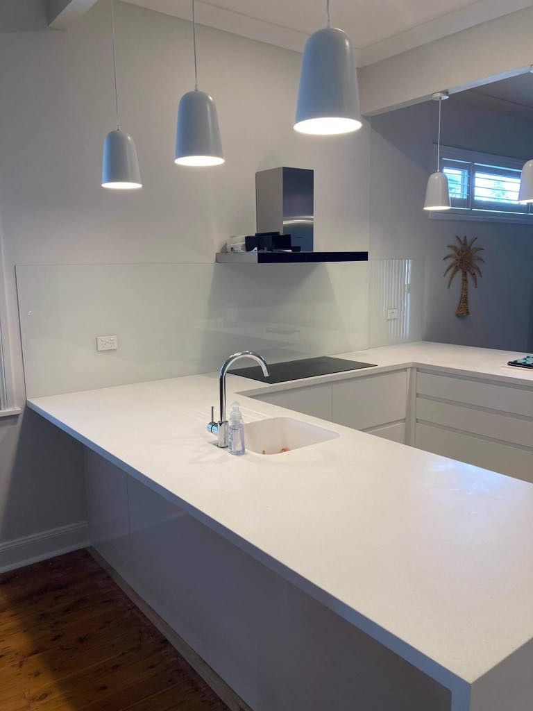 A Kitchen with White Counter Tops, a Sink, and A Stove — Colour Splash in Lake Macquarie, NSW