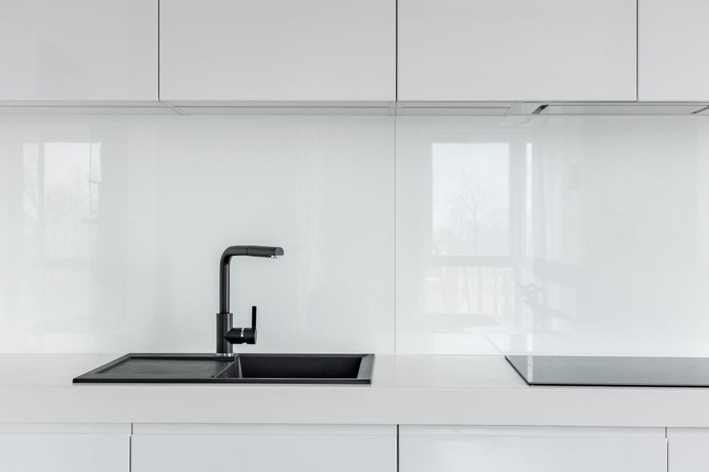 A Kitchen with White Cabinets, a Black Sink, and A Black Stove Top Oven — Colour Splash in Port Stephens, NSW