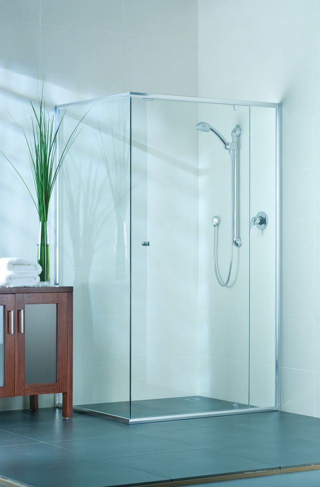 Modern white kitchen with a large marble-look island and wooden bar stools. Stainless steel appliances and light fixtures — Colour Splash in Nelson Bay, NSW