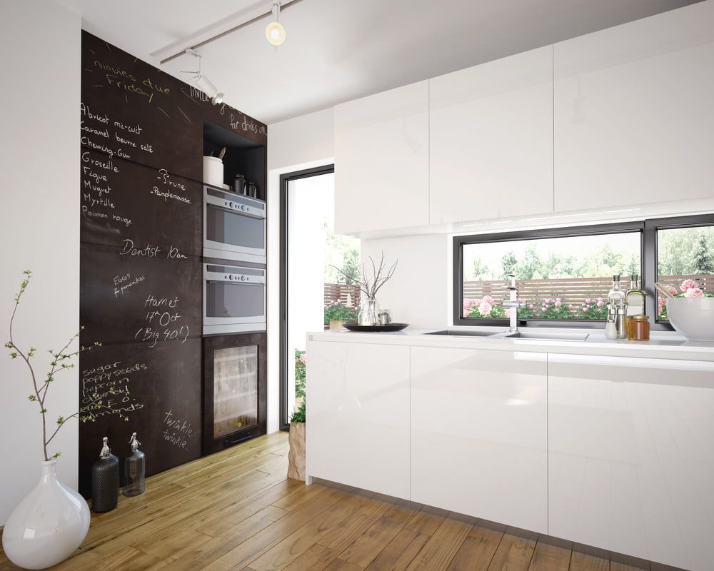 A Kitchen with White Cabinets and A Blackboard on The Wall — Colour Splash in Mayfield, NSW