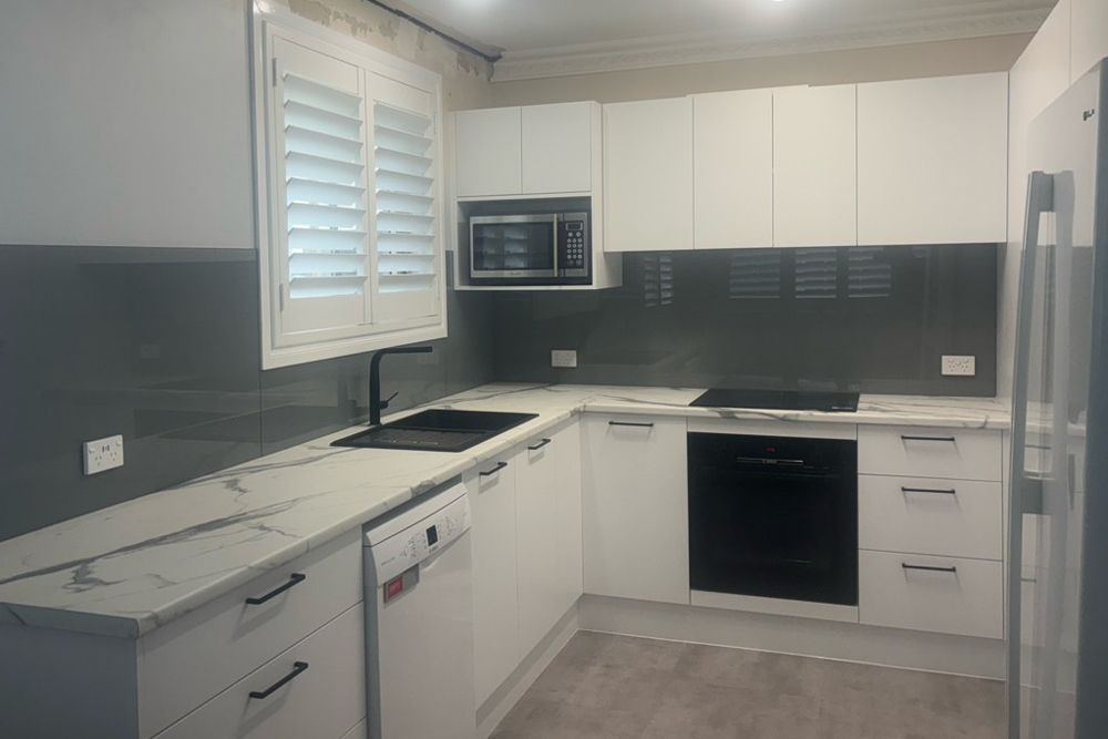 Kitchen with Metallic Glass Splashback