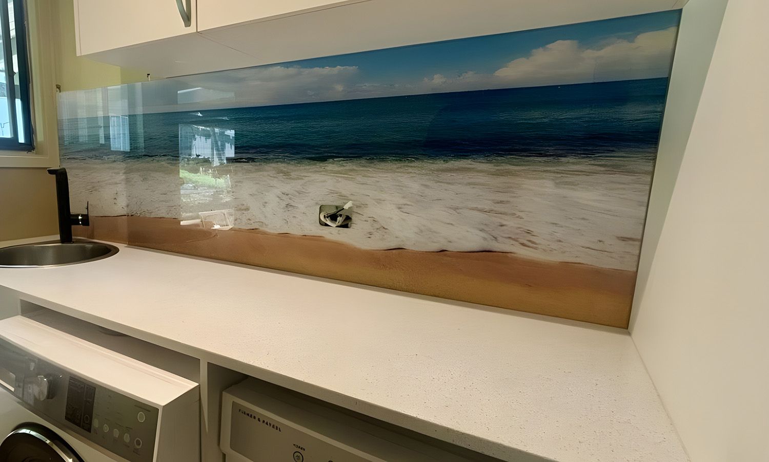 Laundry Room With Printed Beach Scene Backsplash