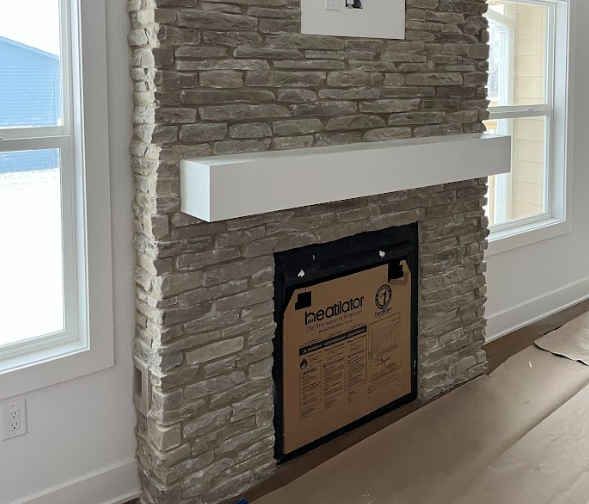 A bathroom with a sink , toilet , shower and mirror.