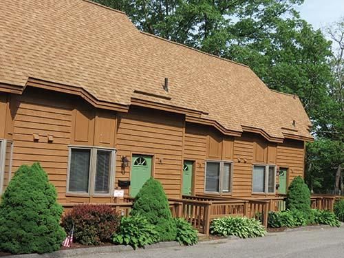 A row of brown houses with green doors