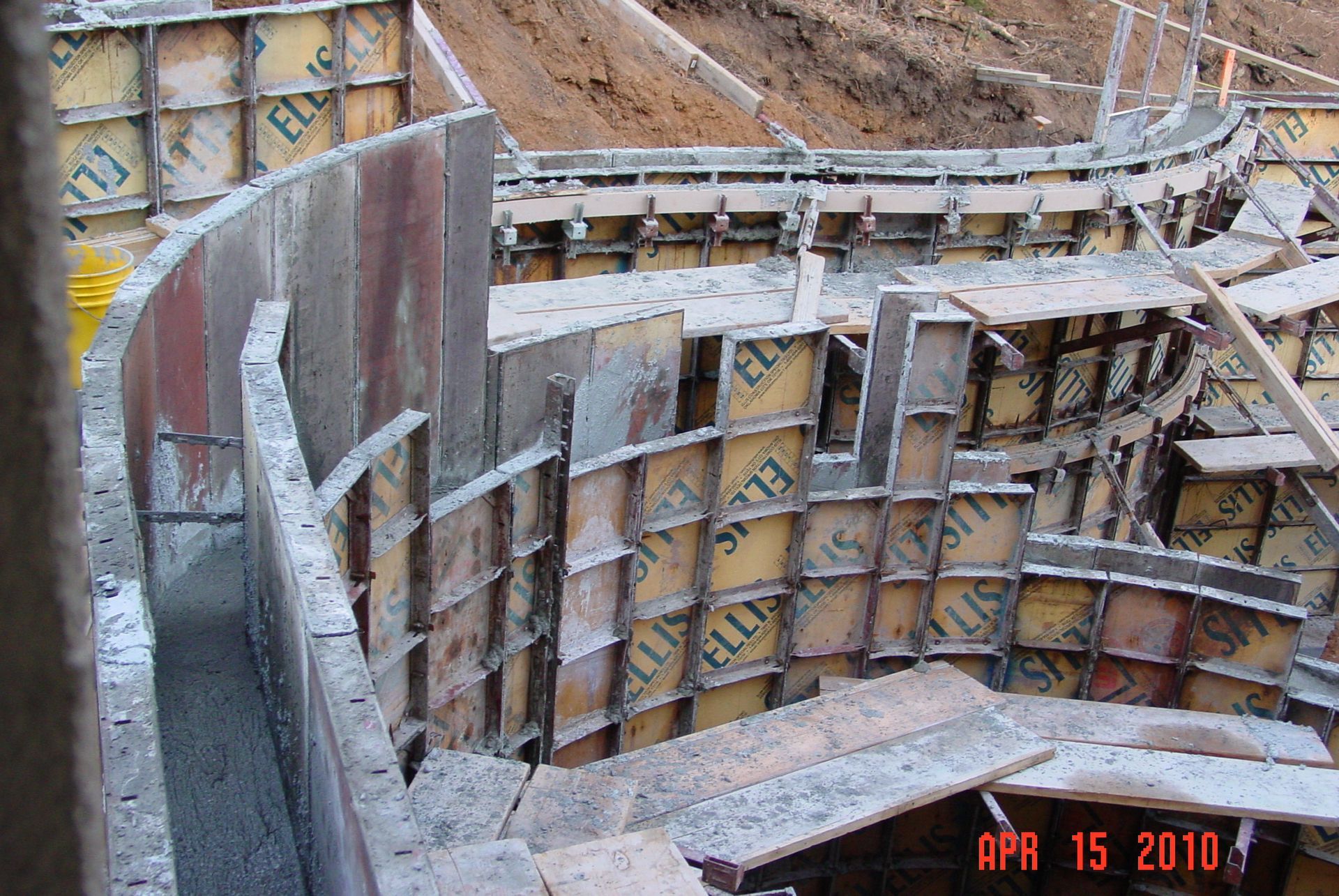 A red car is parked in front of a modern house.