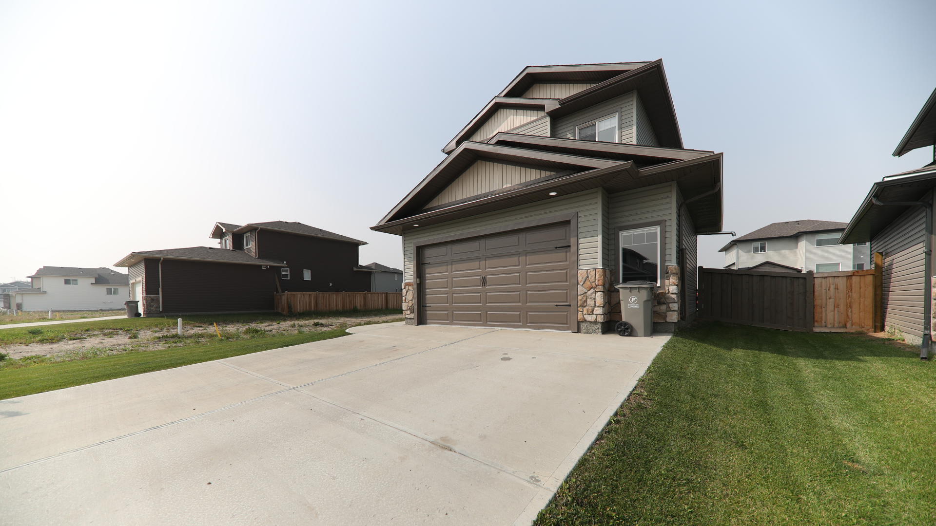 A white house with a table and chairs in front of it