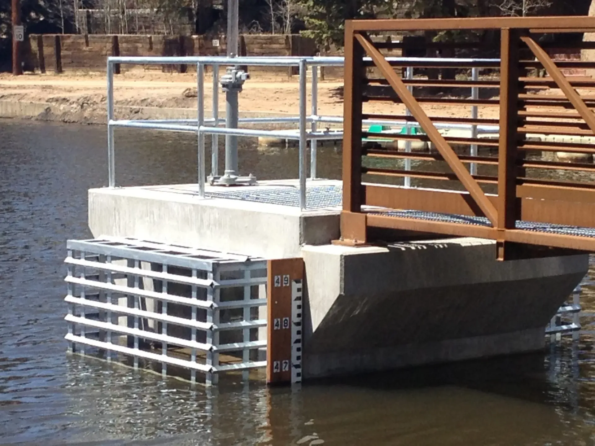 Overhead view of a building under construction. Steel framework, concrete foundation, and HVAC units are visible.