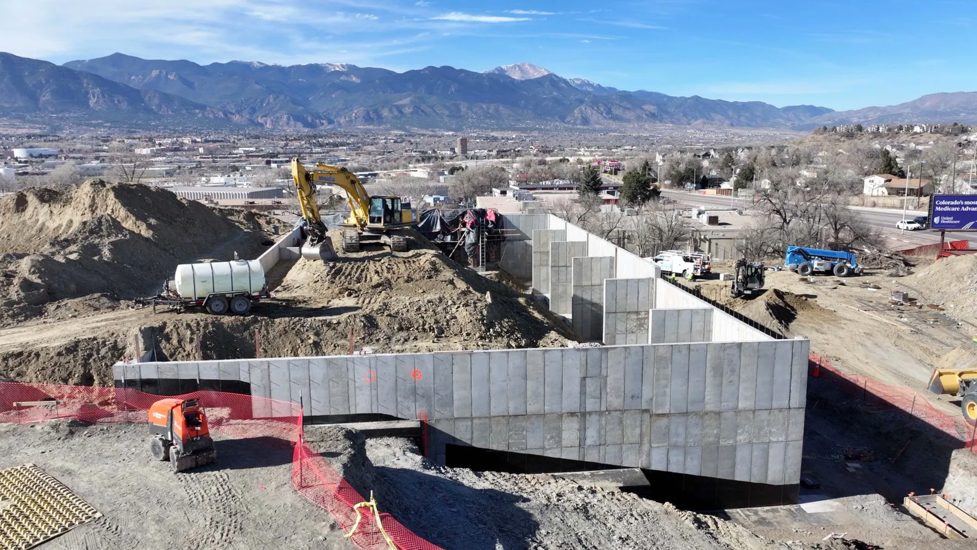 Commercial concrete retaining wall under construction at a site development project in Colorado Springs.