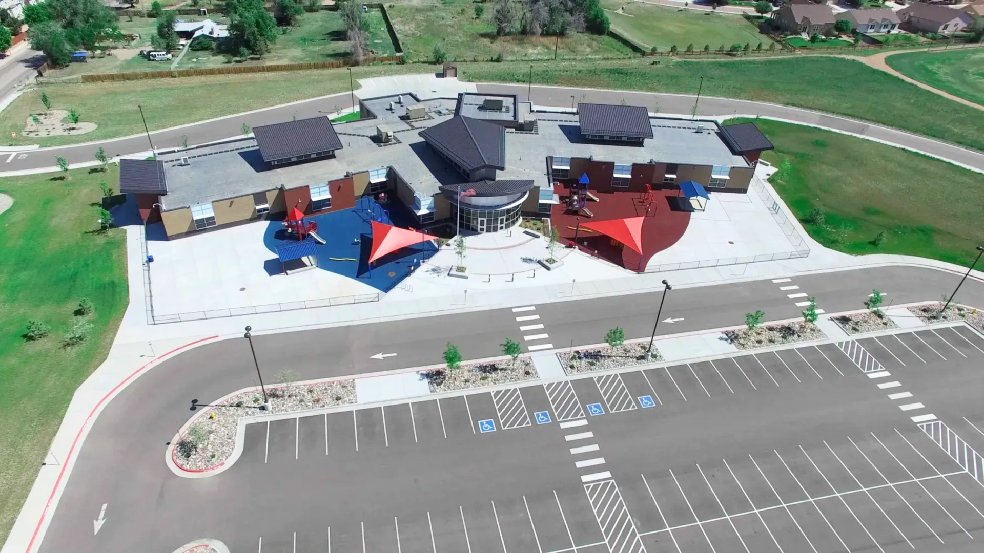 Aerial view of completed commercial concrete flatwork including parking lot, curb and gutter