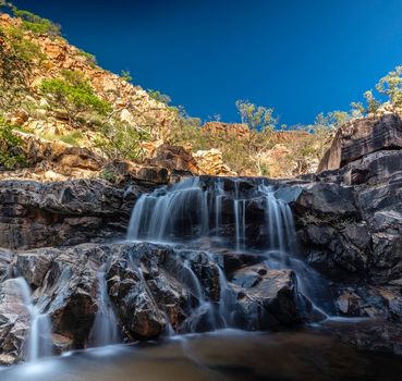 A Waterfall Surrounded By Rocks And Trees — Custom Steel Fab in Cloncurry, QLD