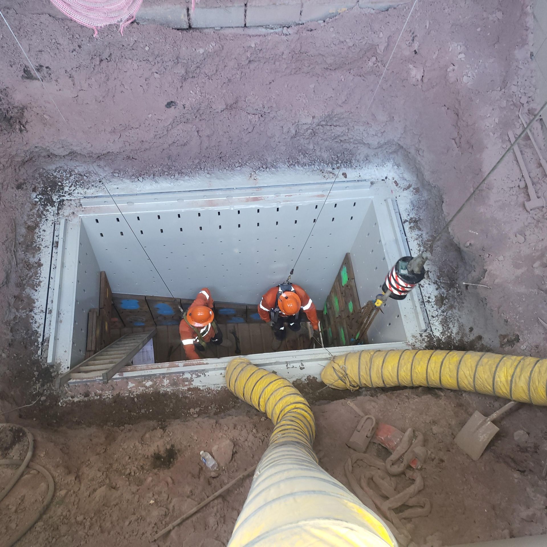 A Group Of Men Are Working In A Hole In The Ground — Custom Steel Fab in Garbutt, QLD