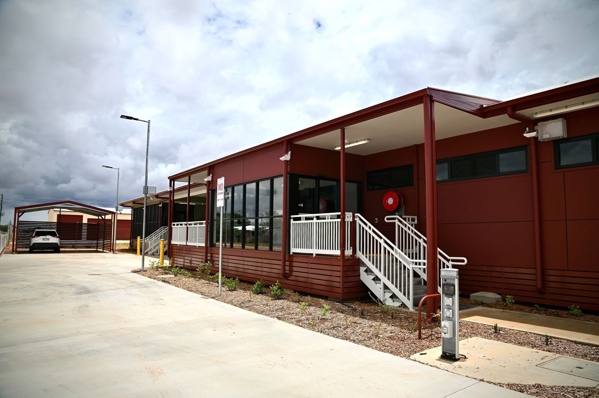 A Large Red Building With Stairs Leading Up To It — Custom Steel Fab in Garbutt, QLD