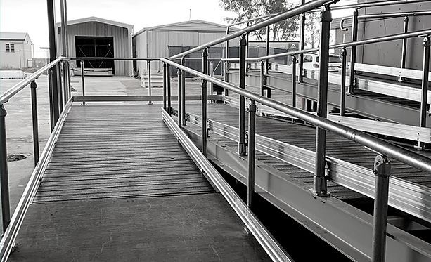 A Black and White Photo of A Ramp with A Railing — Complete Fabrication in Townsville