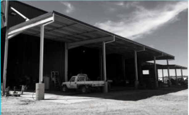 A Truck Is Parked Under a Canopy in Front of A Building — Complete Fabrication in Townsville