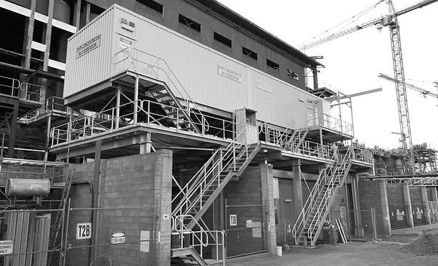 A Black and White Photo of A Building Under Construction with Stairs Leading up To It — Complete Fabrication in Townsville