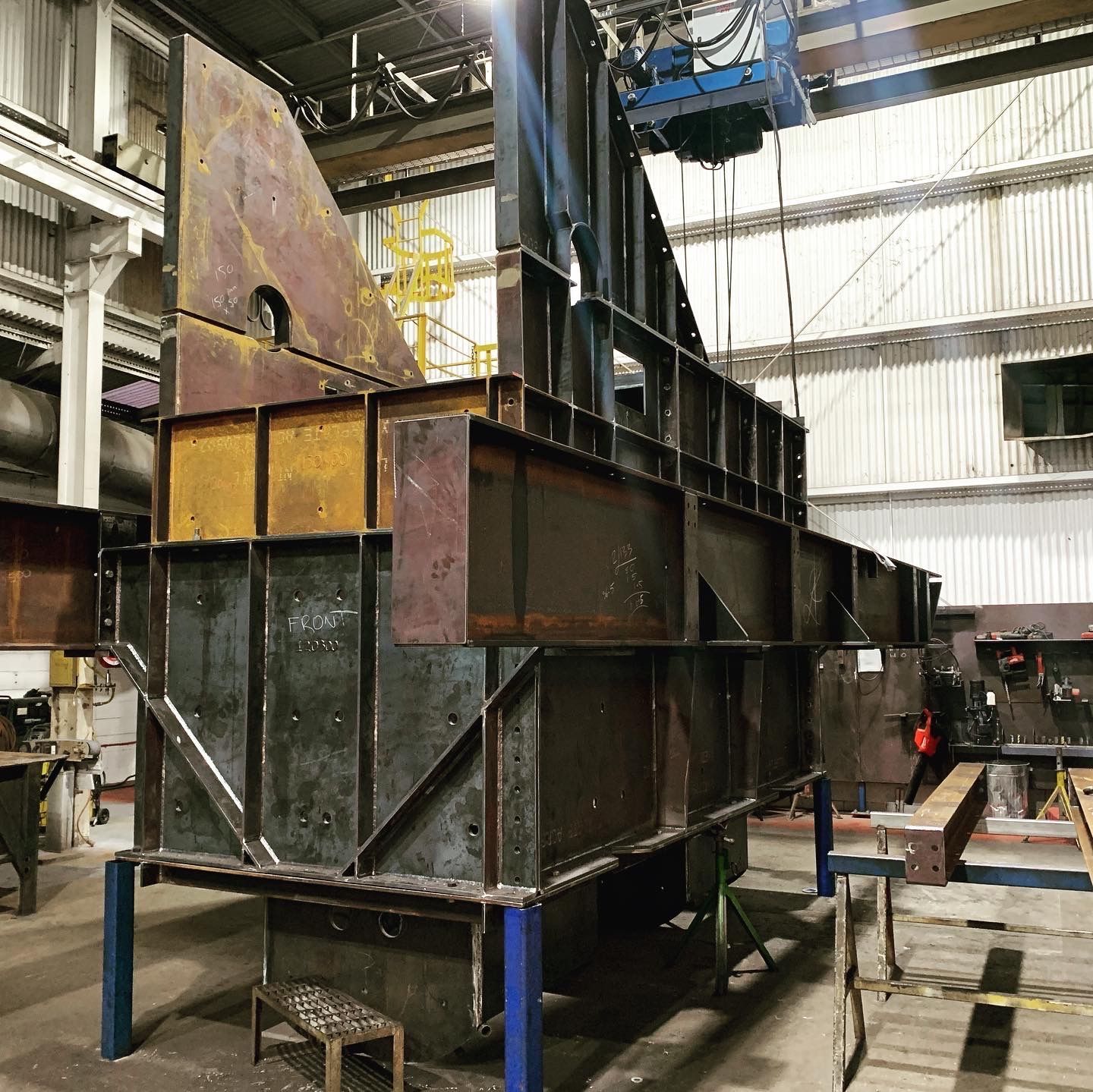 A Large Metal Structure Is Being Built In A Factory — Custom Steel Fab in Garbutt, QLD