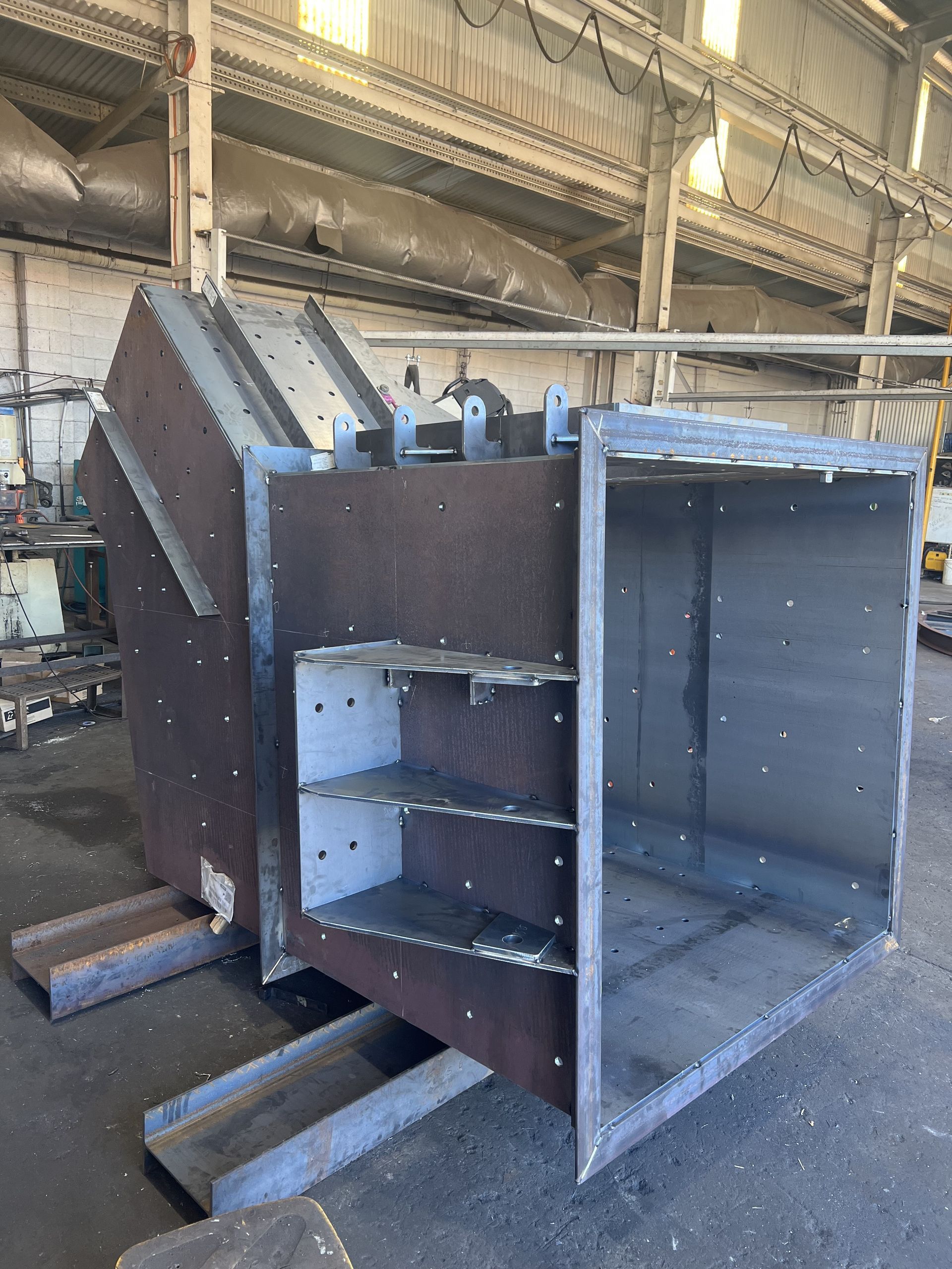 A Large Piece Of Metal Is Sitting In A Warehouse — Custom Steel Fab in Garbutt, QLD