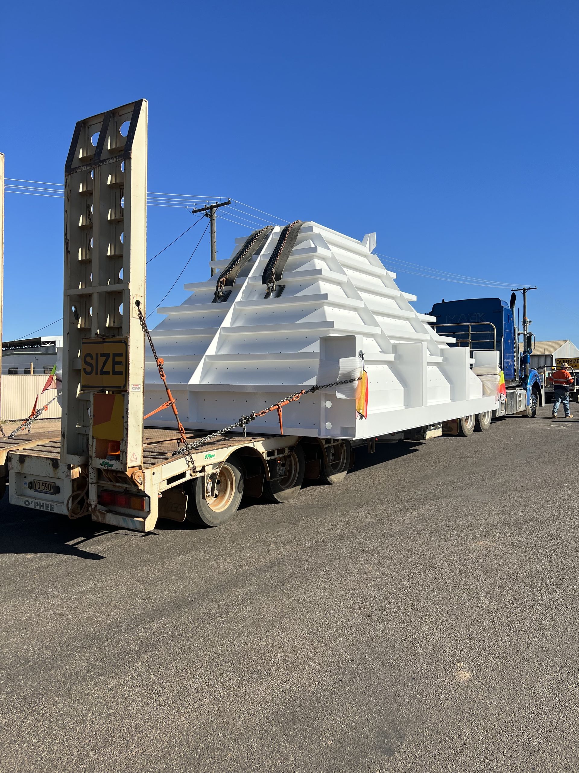 A Large White Pyramid Is Being Transported On A Trailer — Custom Steel Fab in Garbutt, QLD