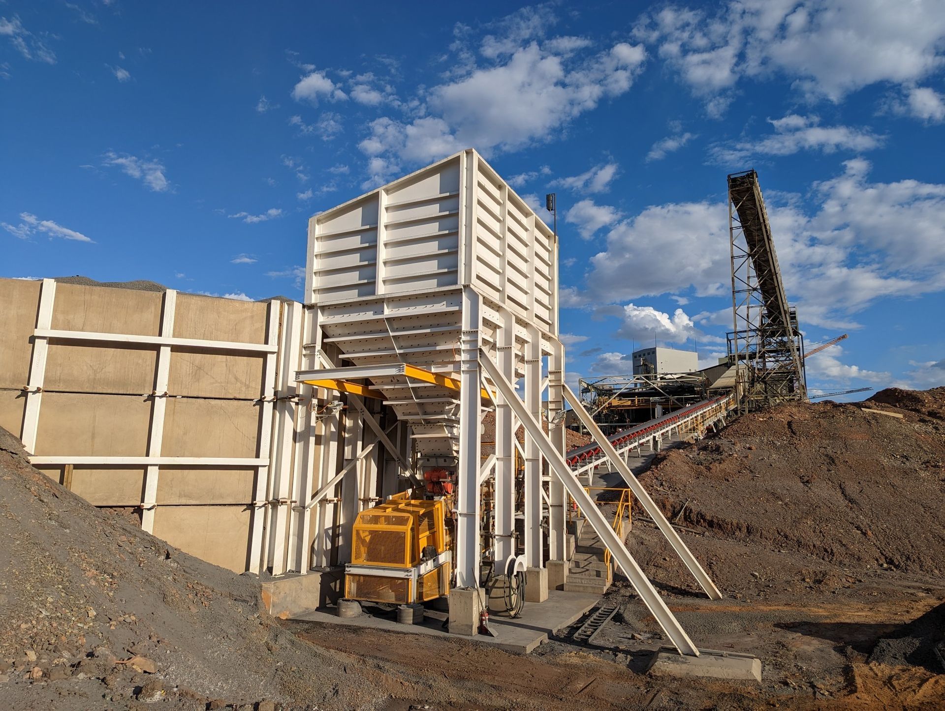 A Yellow Truck Is Parked In Front Of A Large Pile Of Dirt — Custom Steel Fab in Mackay, QLD