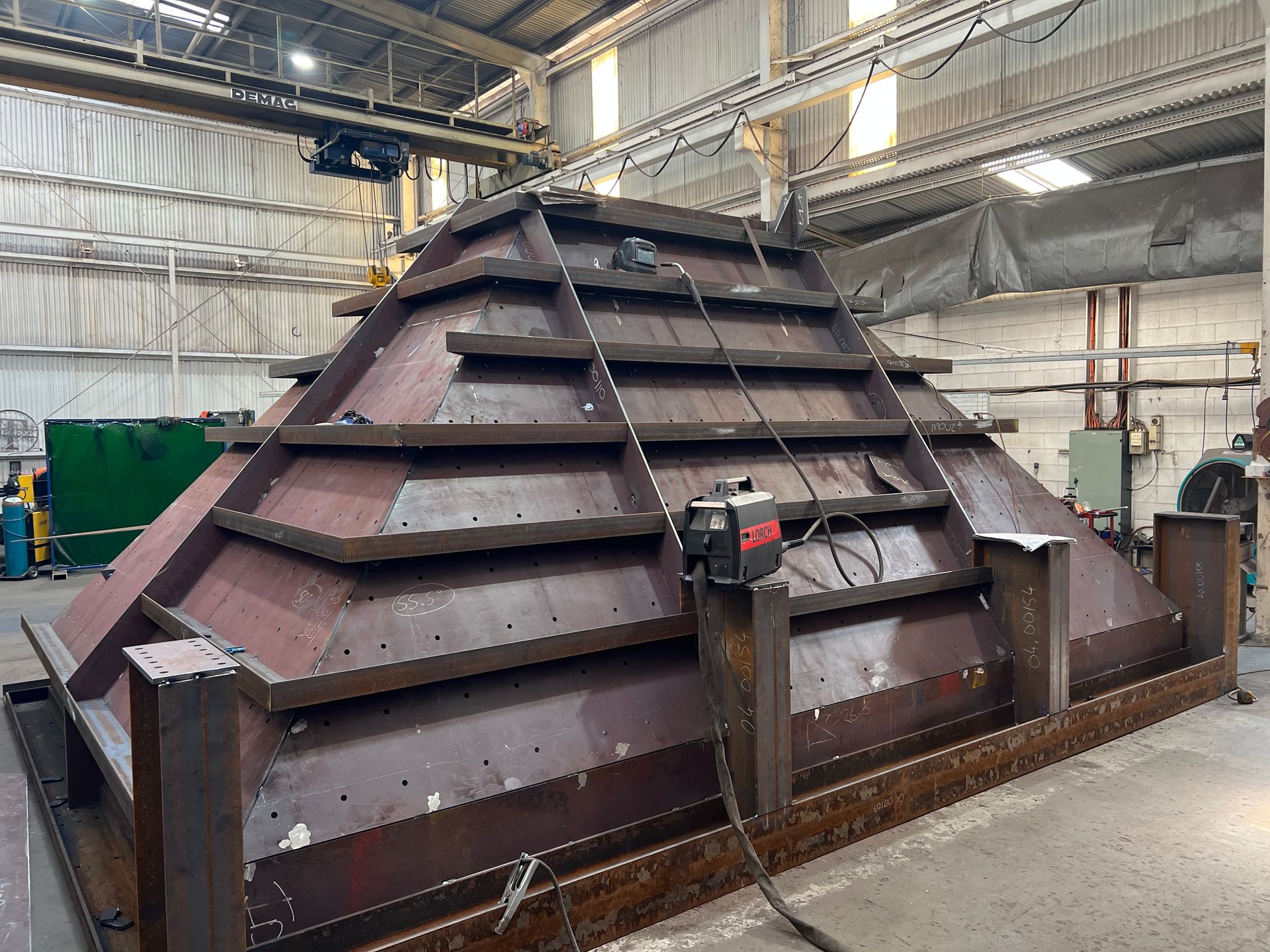 A Large Metal Structure Is Being Built In A Factory — Custom Steel Fab in Garbutt, QLD