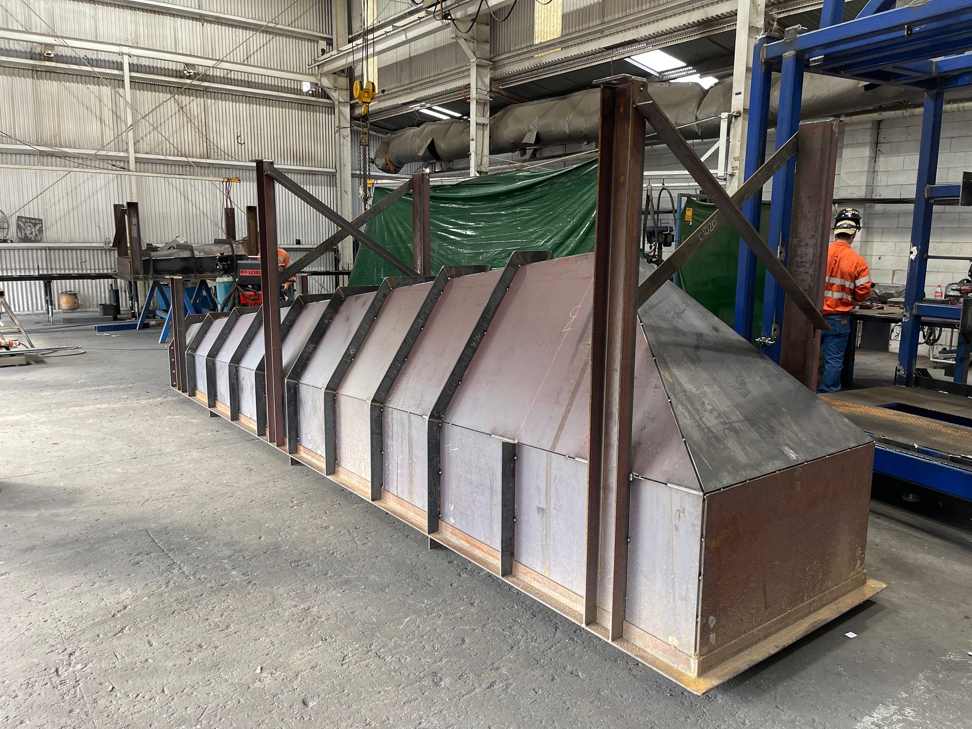 A Large Piece Of Metal Is Sitting In A Warehouse — Custom Steel Fab in Garbutt, QLD