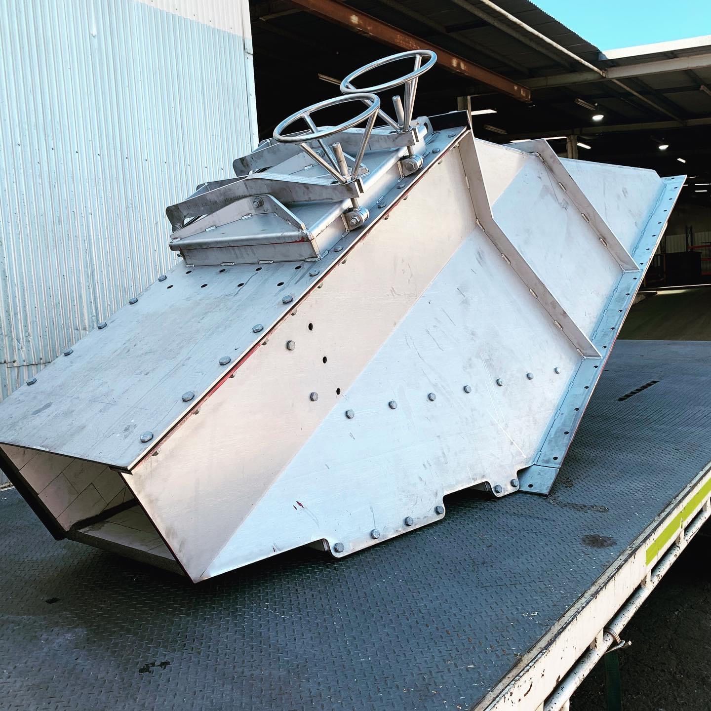 A large piece of metal is sitting on top of a truck