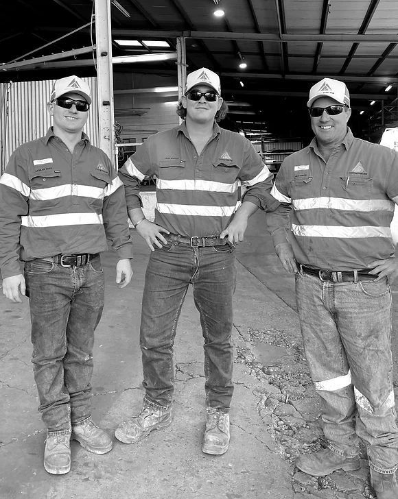 Three Men Are Standing Next To Each Other In A Black And White Photo — Custom Steel Fab in Garbutt, QLD