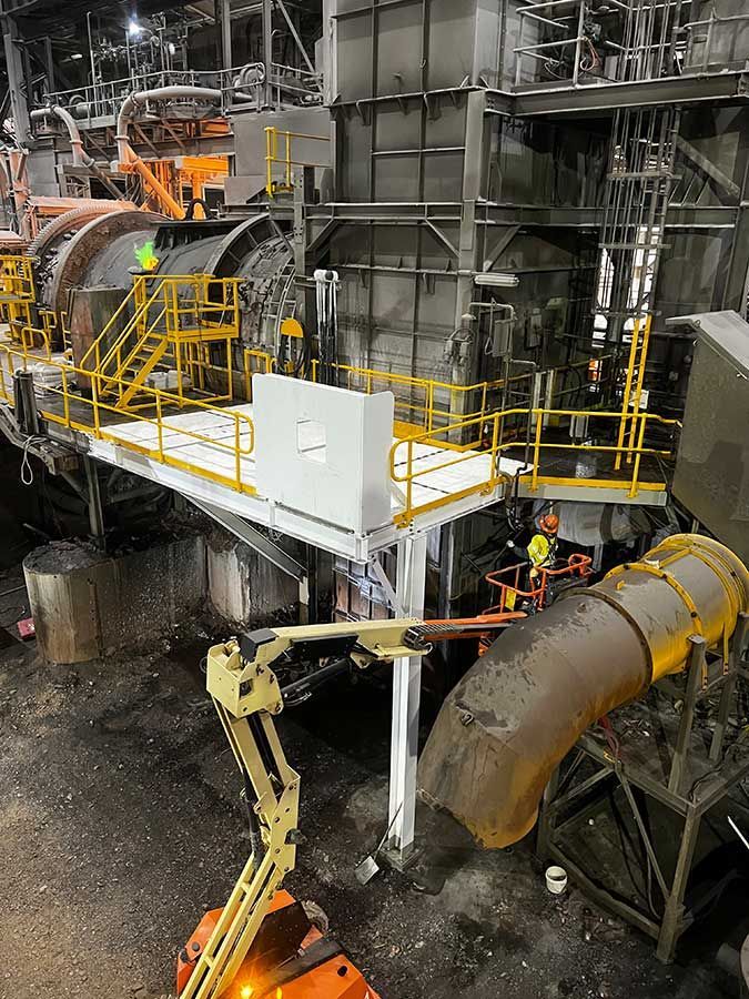 A Group Of People Are Working On A Machine In A Factory — Custom Steel Fab in Alice Springs, NT