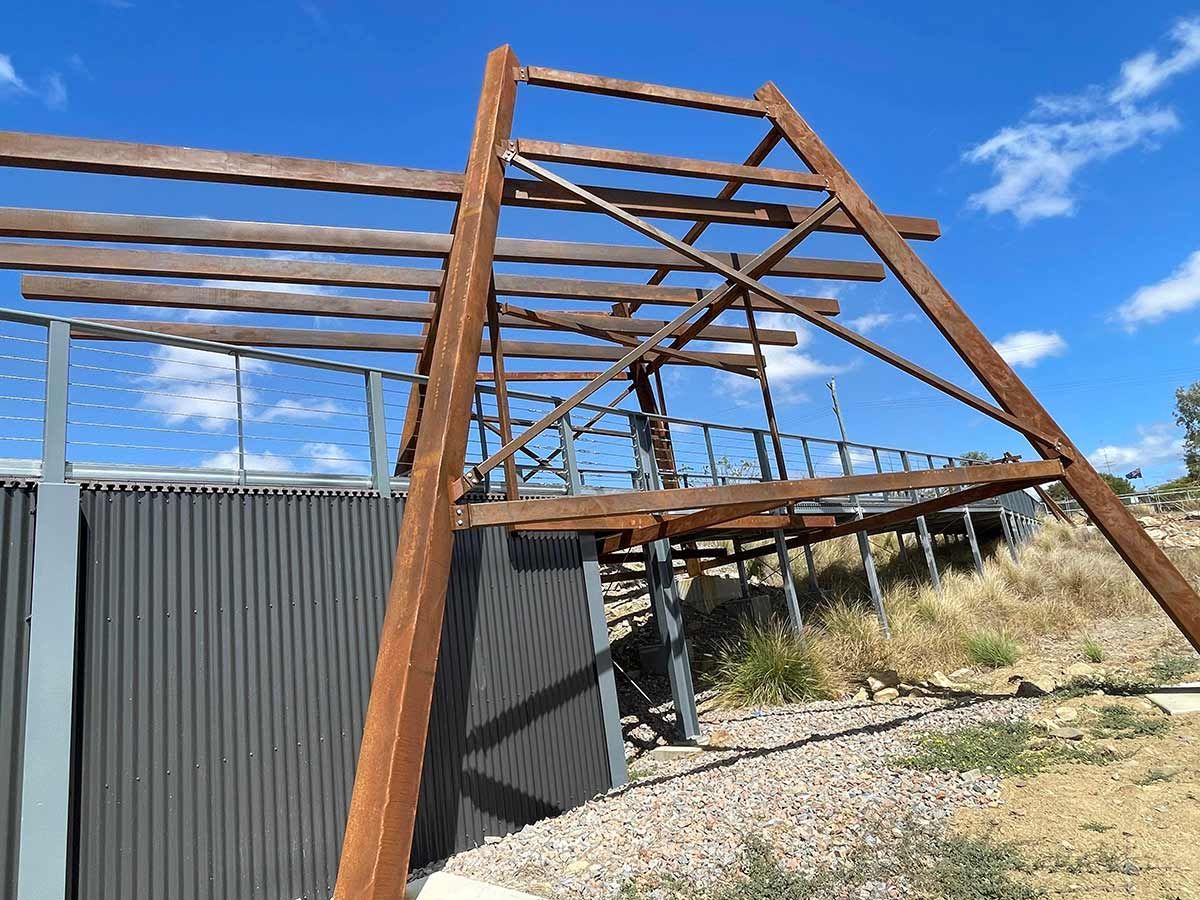 A Wooden Structure With A Blue Sky In The Background — Custom Steel Fab in Alice Springs, NT