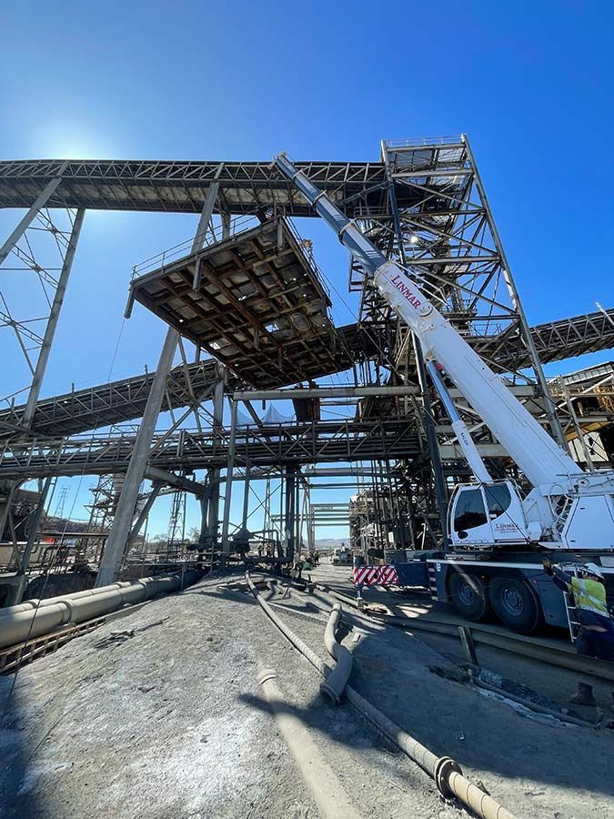 A Large Crane Is Sitting On Top Of A Building Under Construction — Custom Steel Fab in Hughenden, QLD