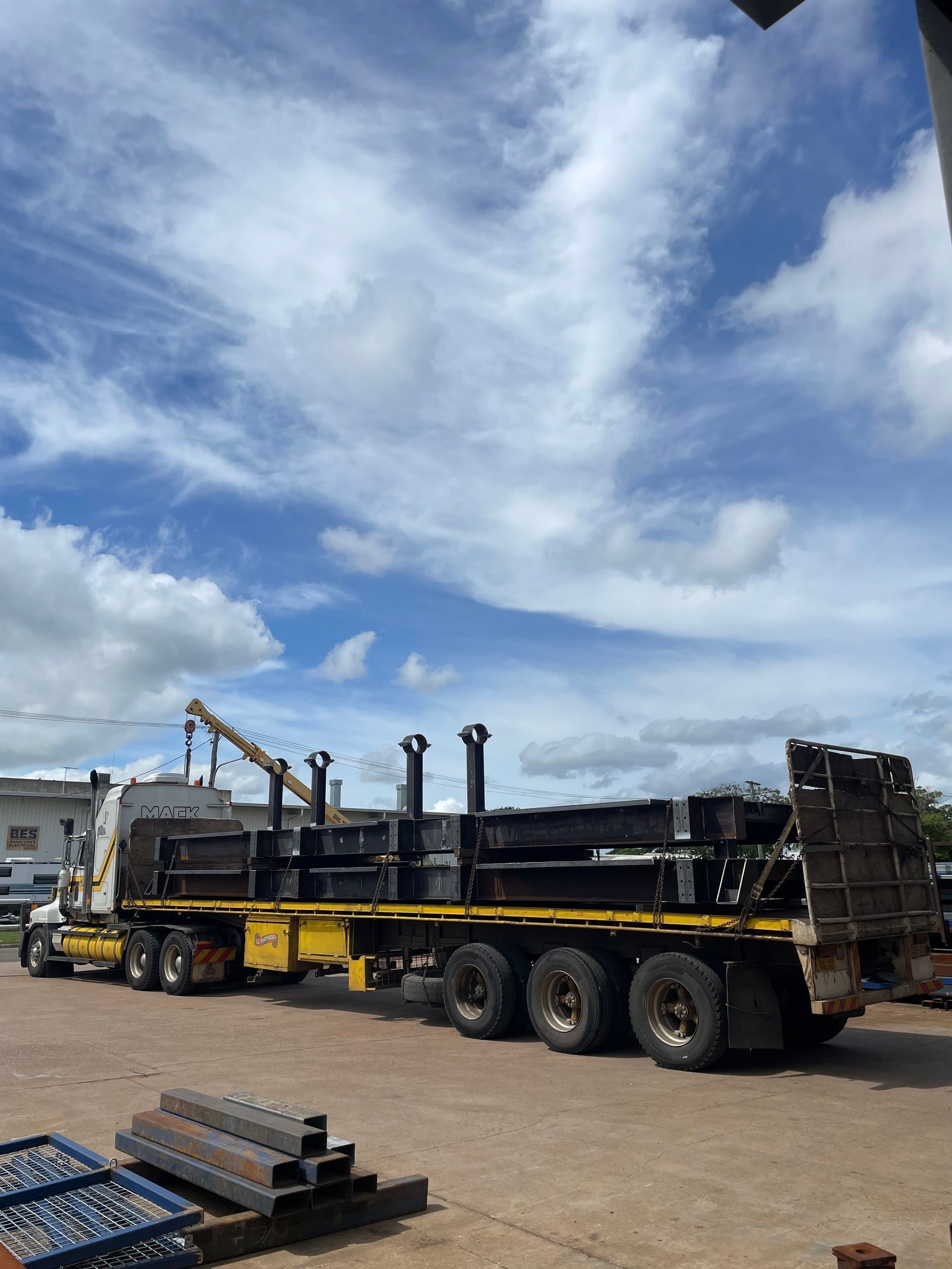 A Semi Truck With A Crane On The Back Is Parked In A Parking Lot — Custom Steel Fab in Garbutt, QLD