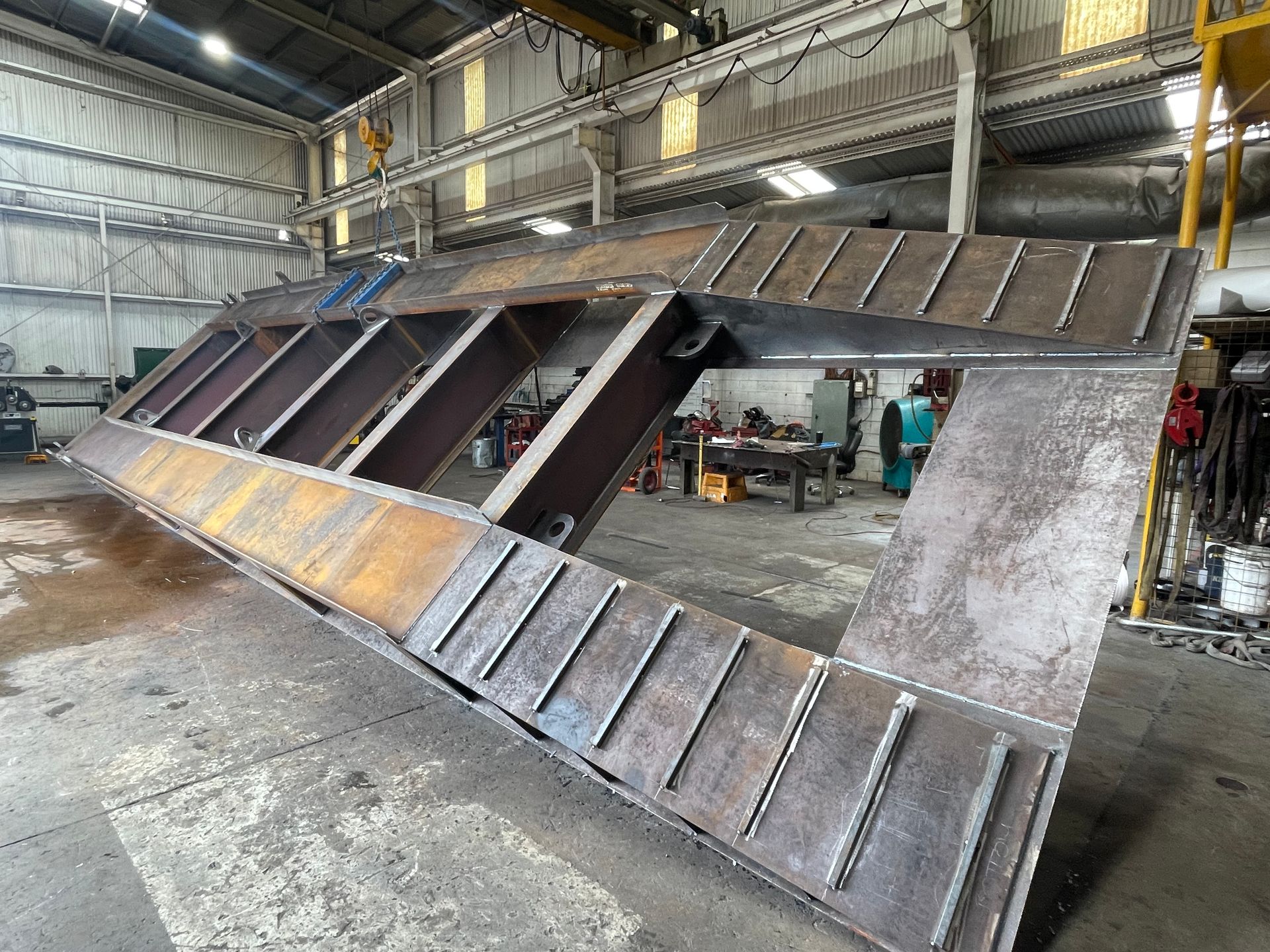 A Large Piece Of Metal Is Sitting On The Ground In A Factory — Custom Steel Fab in Garbutt, QLD