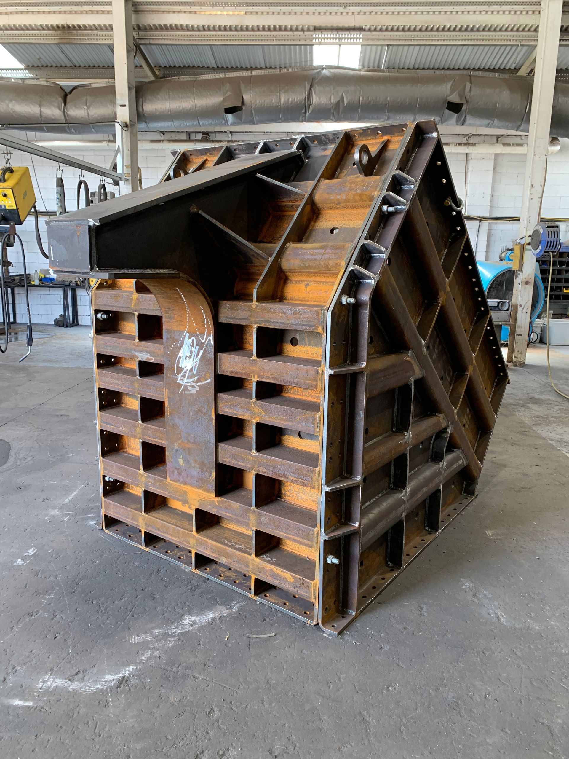 A large piece of metal is sitting in a warehouse.