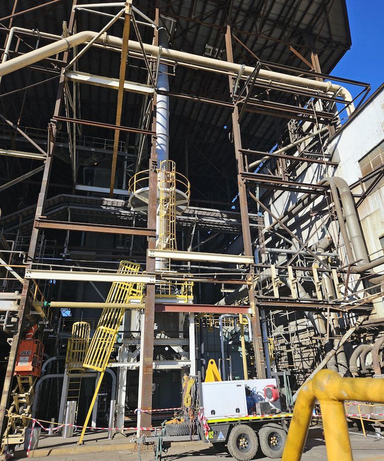 A large building with a lot of pipes and stairs