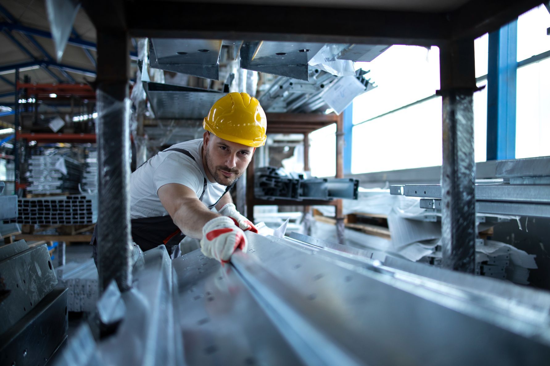 Worker Handling Steel — Custom Steel Fab in Emerald, QLD