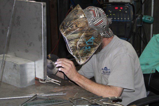 Man Working On Metal — Olivia, NC — Olivia Machine & Tool, Inc