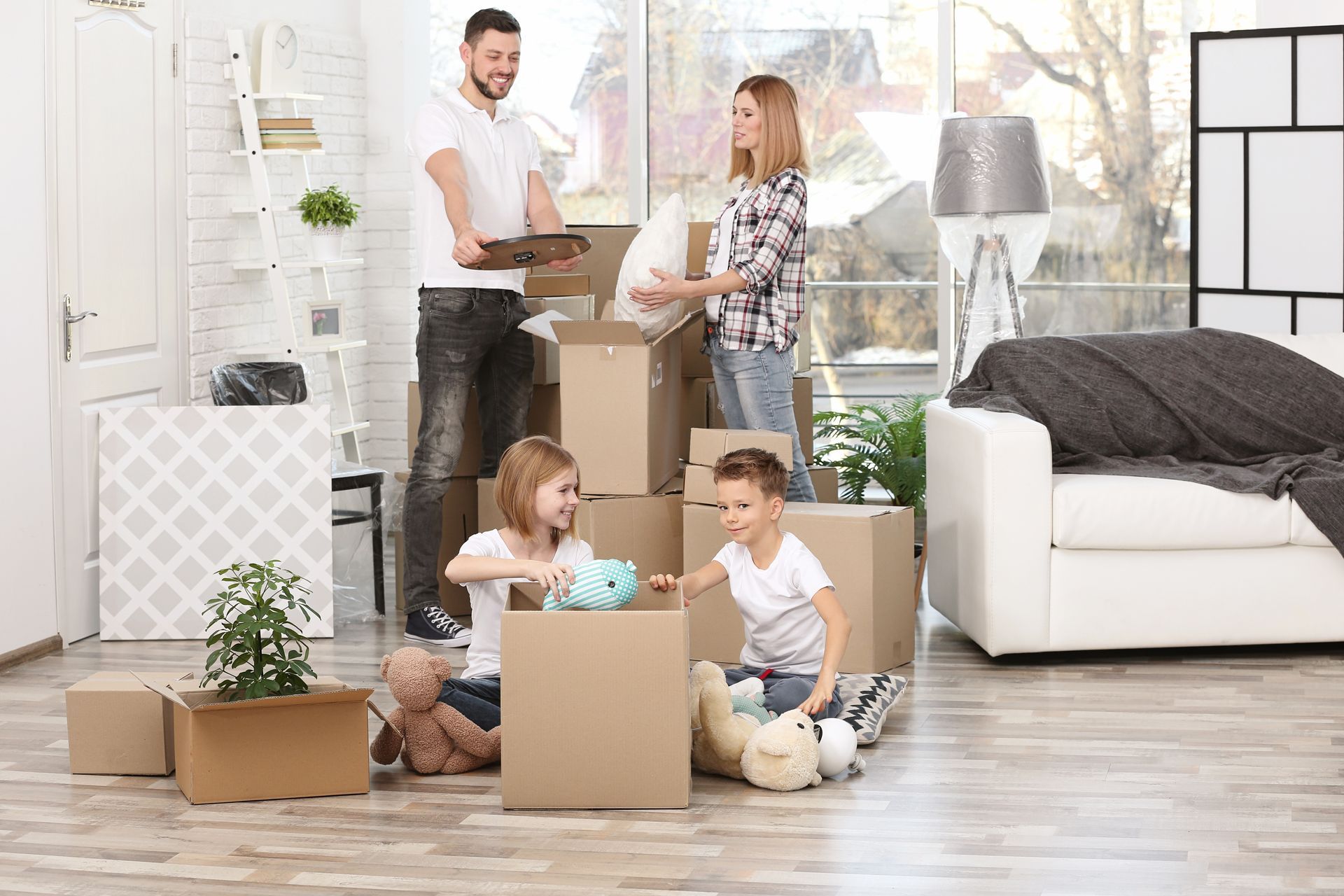 A family unpacking cardboard boxes in a new home.