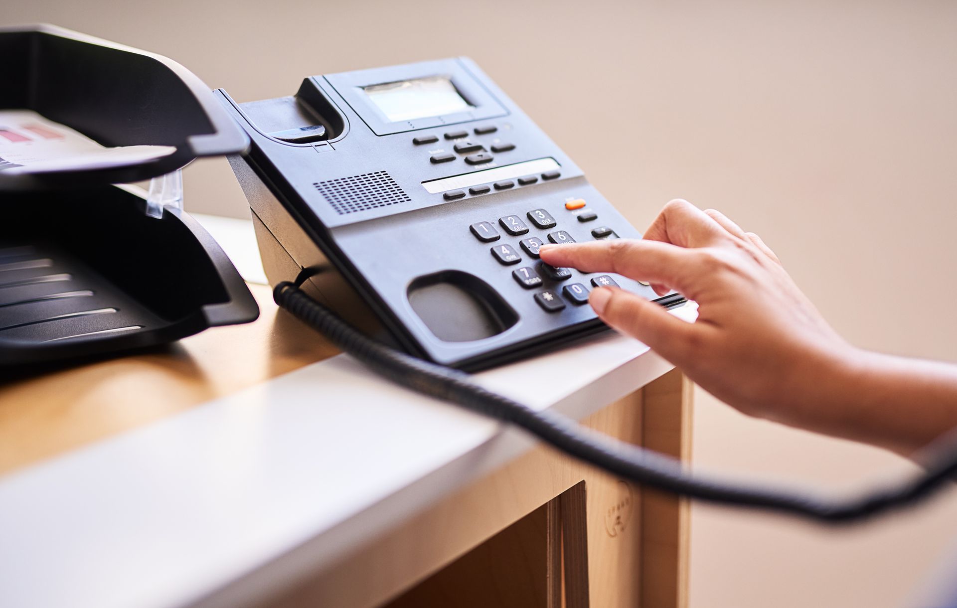Two Women Are Sitting at A Table with Laptops and Talking to Each Other.