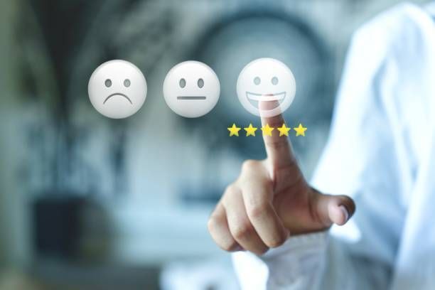 A Woman Is Holding a Tablet in Her Hands and Smiling at The Camera.