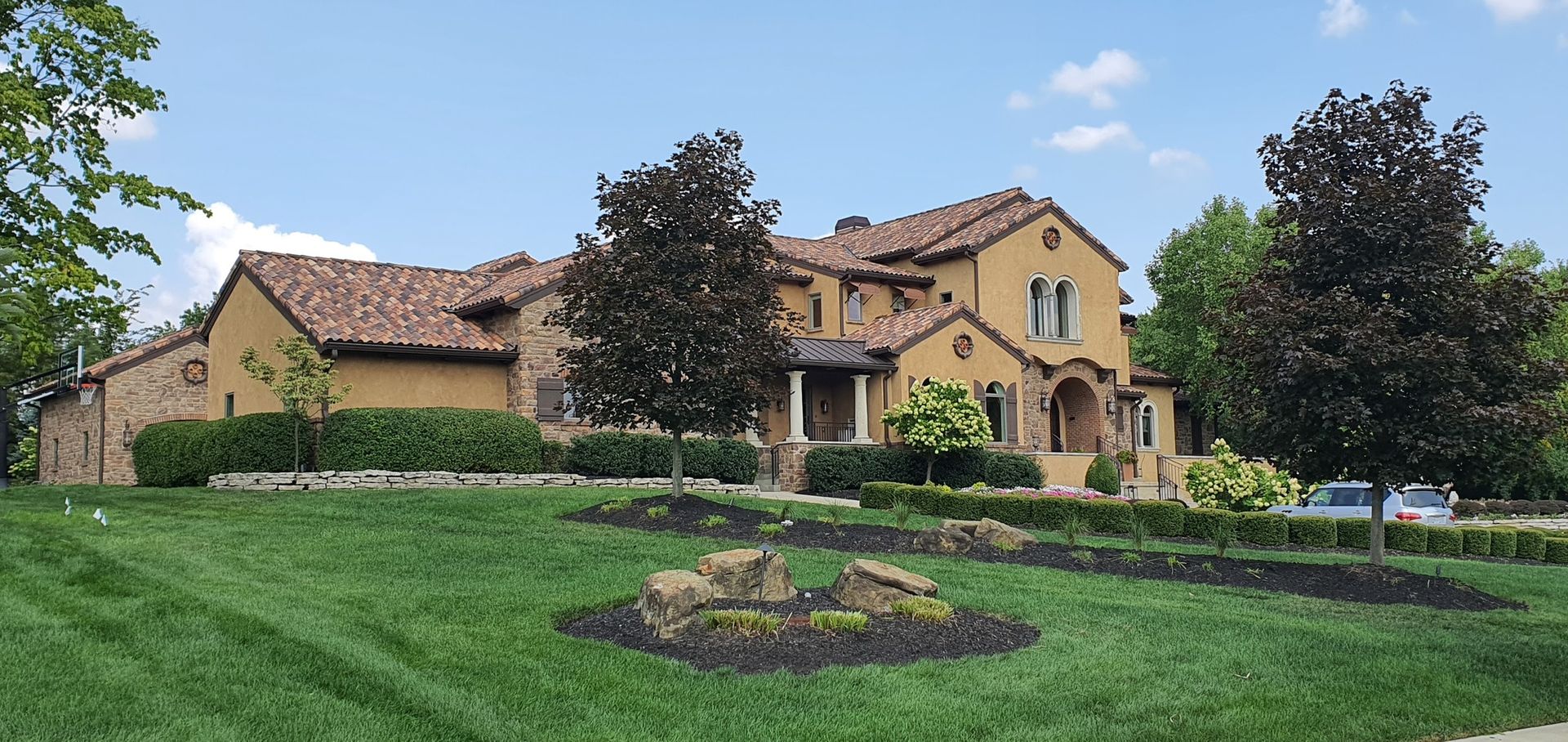 A large house with a lush green lawn in front of it