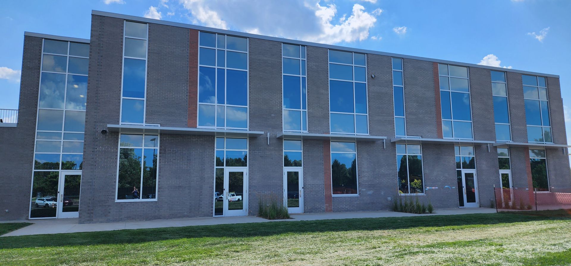 A large brick building with a lot of windows on a sunny day.