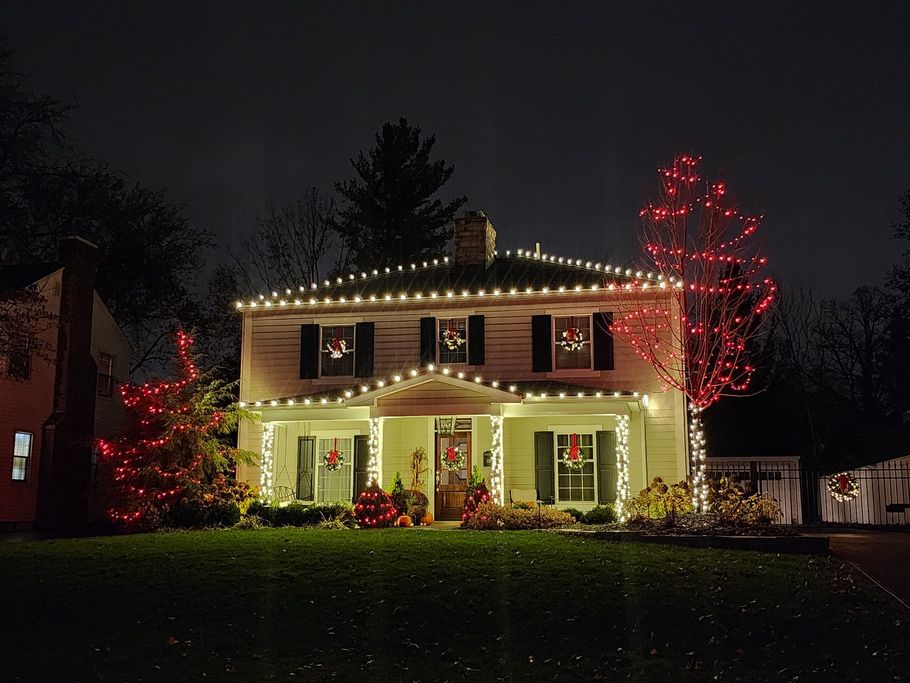 A house decorated for christmas with red and white lights