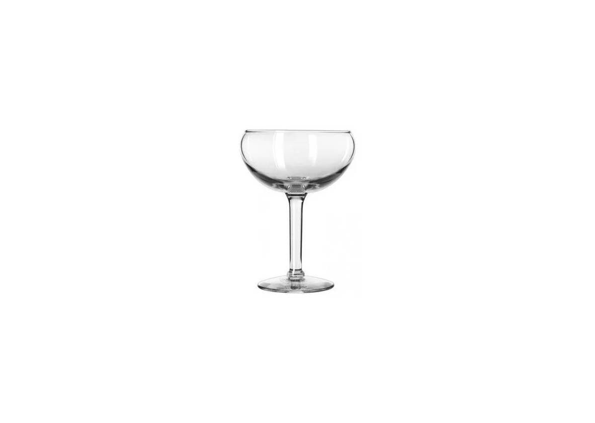A clear glass coupe cocktail glass with a wide, shallow bowl and a thin stem, isolated against a white background.