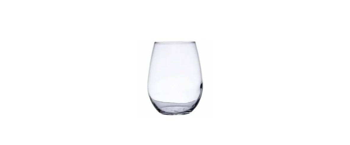 A clear, stemless wine glass against a white background.