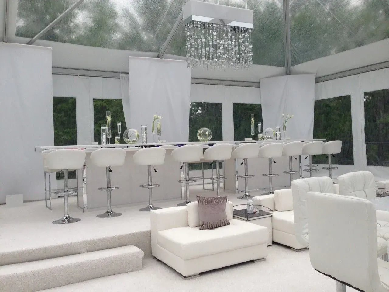 A stainless steel commercial food service rolling rack with multiple tray slots on four wheels against a white background.