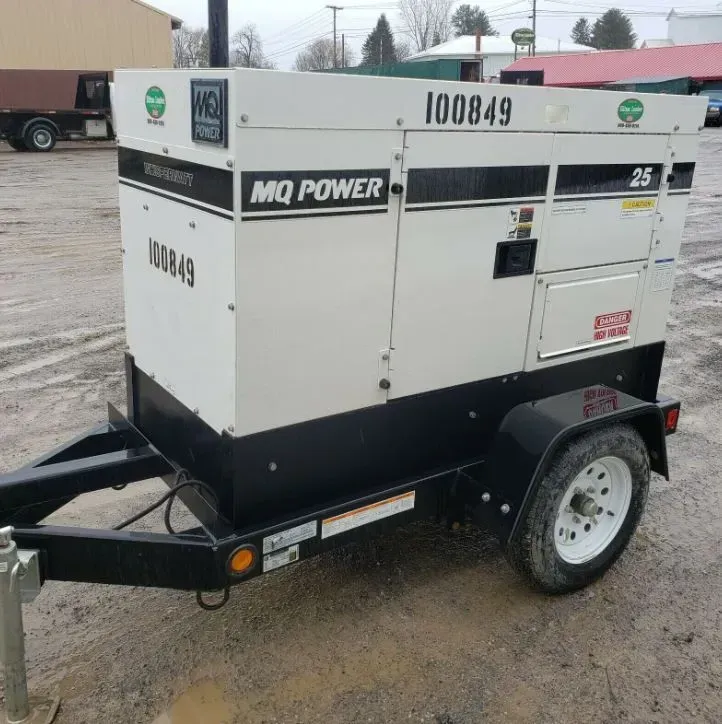 A white and black MQ Power portable generator trailer with the asset number 100849 parked on a gravel lot.