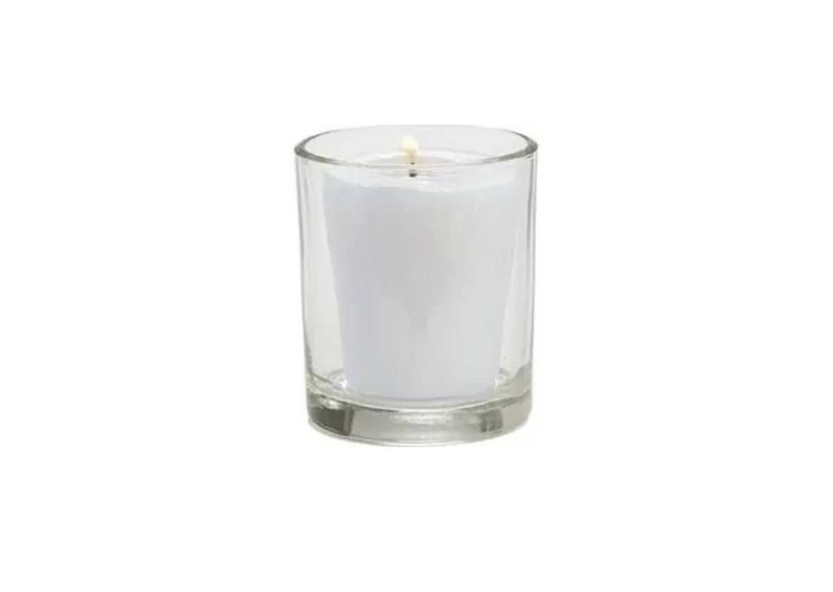 A small white votive candle inside a clear, cylindrical glass holder against a white background.